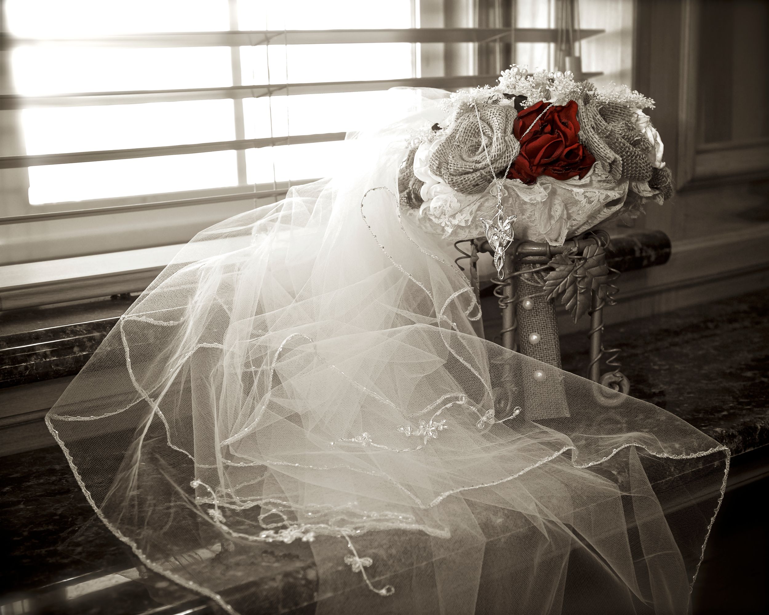 A series of six black and white photos showing a flowing wedding dress train with delicate lace details.