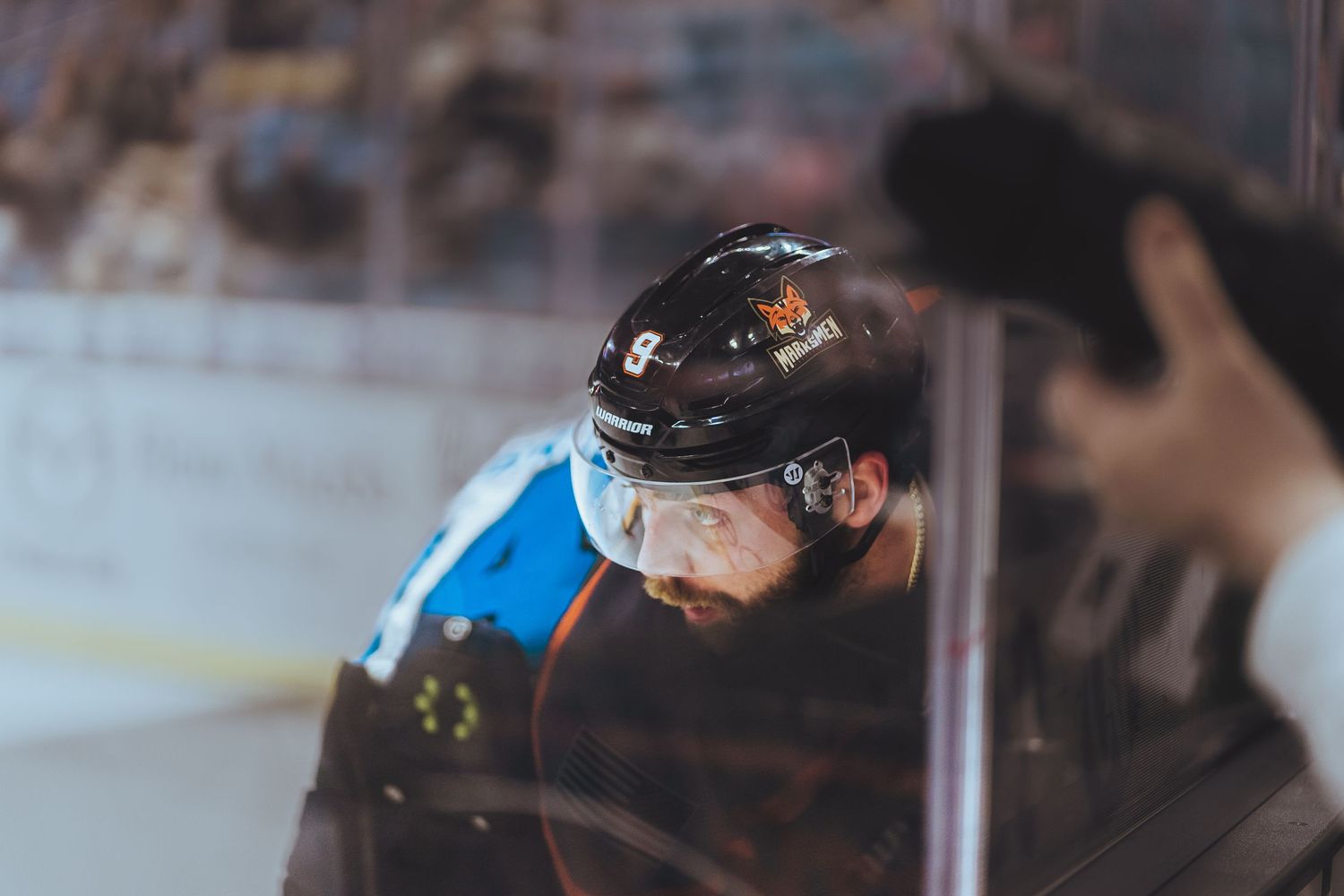 Close-up of hockey player wearing protective helmet during game.