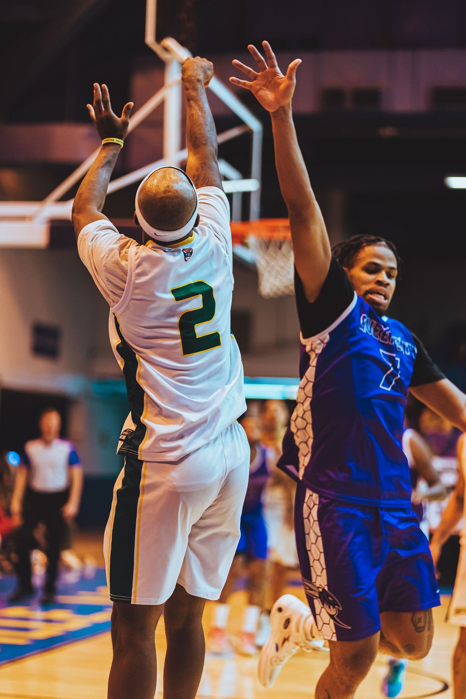 Two basketball players battle for position during intense game action.