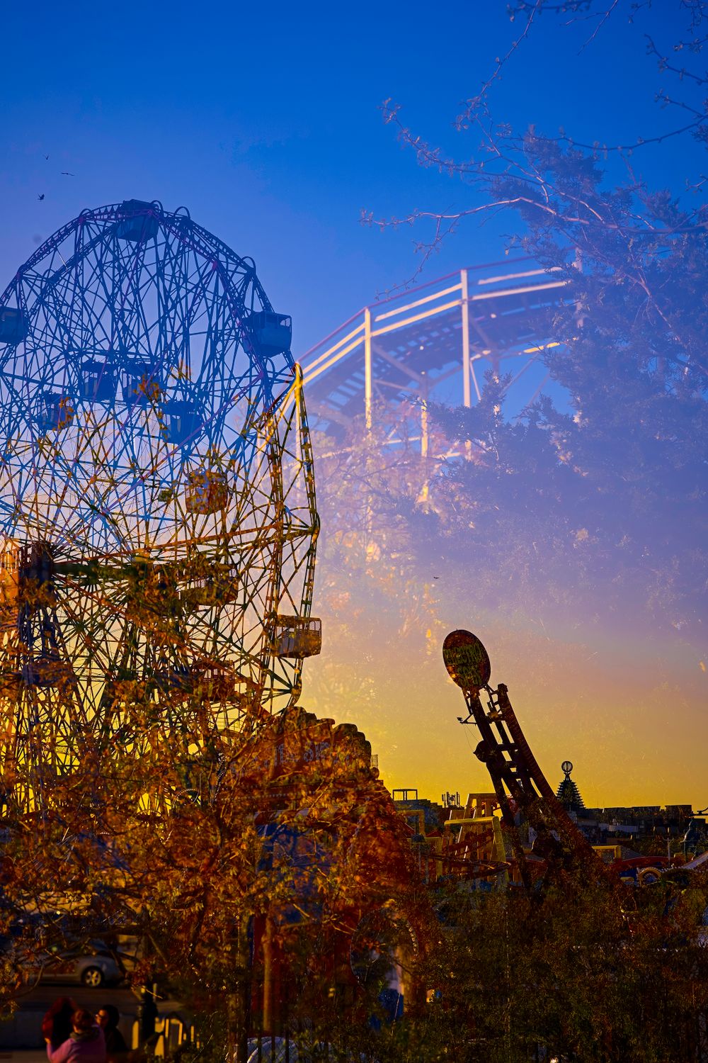 Historic Wonder Wheel silhouetted against vibrant sunset sky at Coney Island.