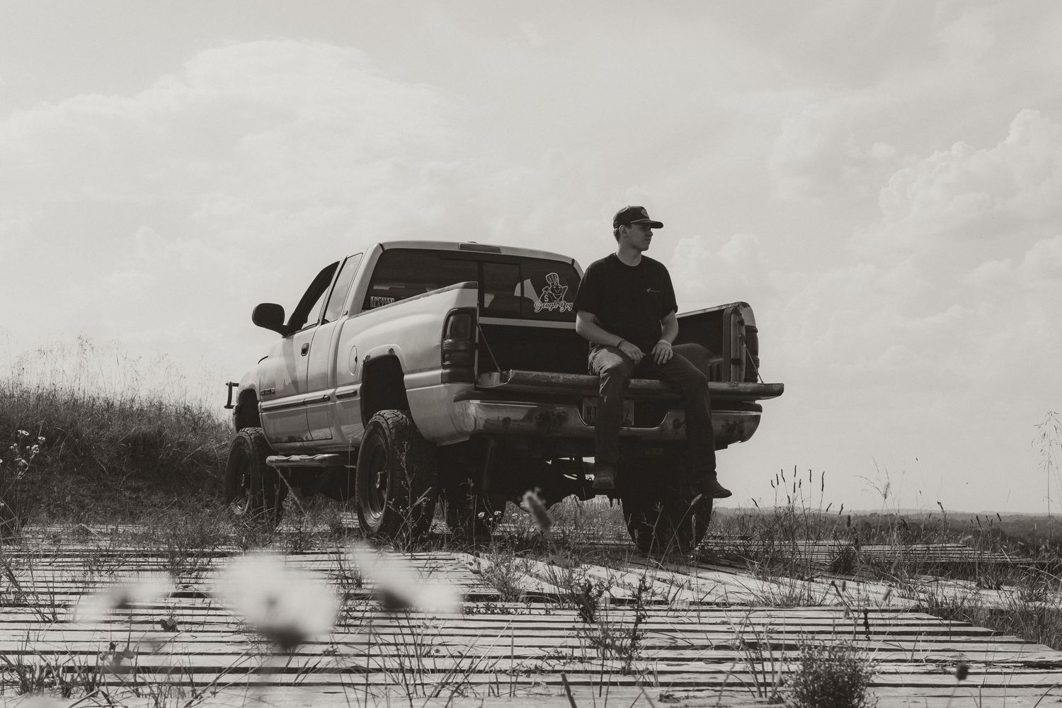 A sequence of black and white photographs showing a car jumping and rolling over in a dramatic stunt sequence.