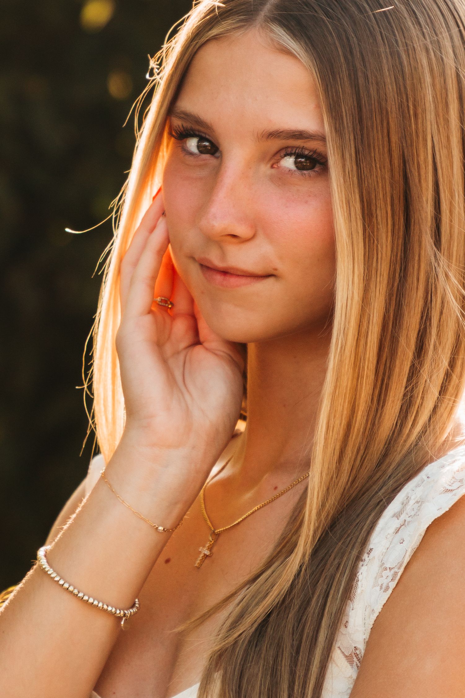 Portrait photo series showing a person with blonde hair in white lace clothing against a sunlit outdoor background.