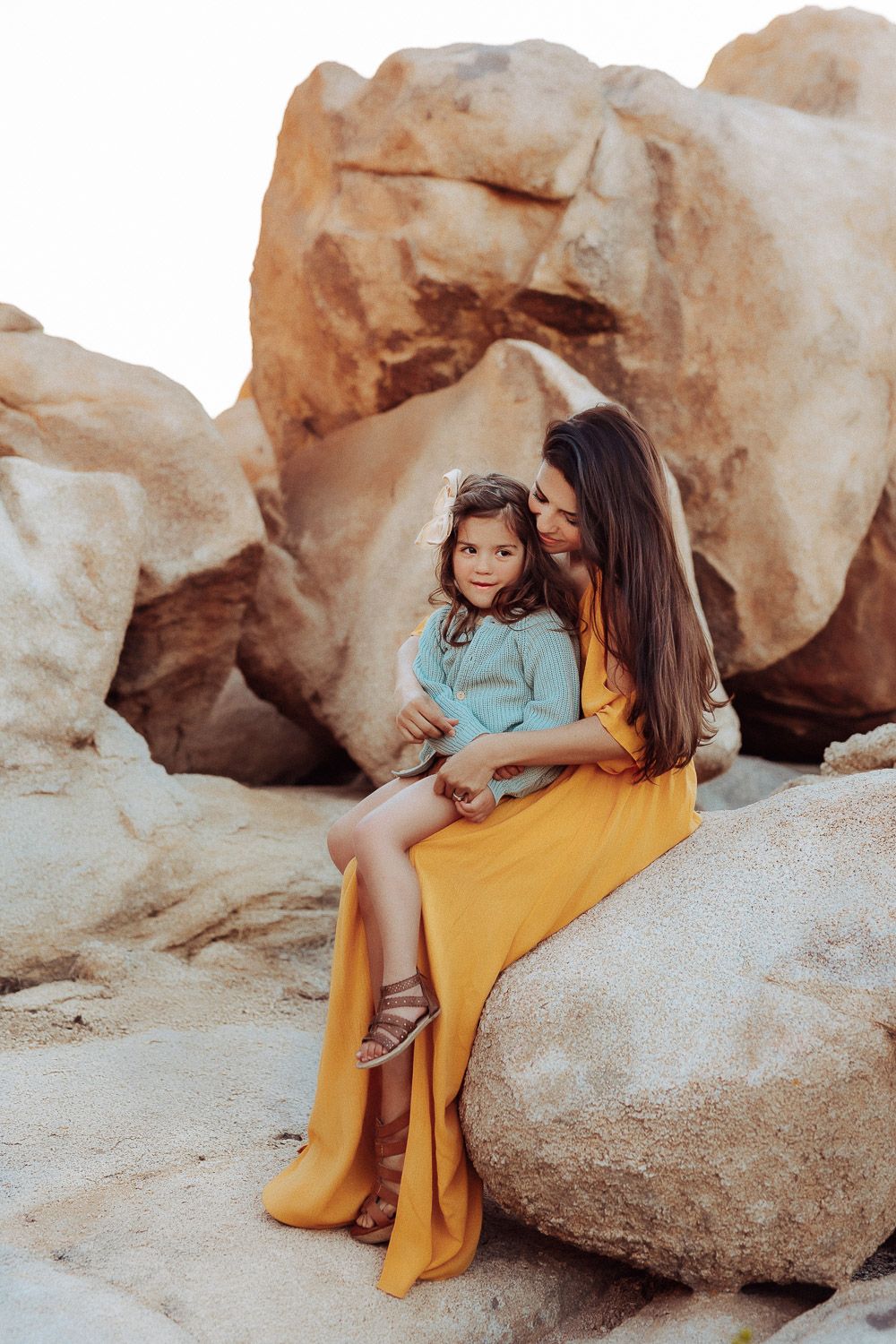 Loving mom and daughter enjoying a moment together in the desert at Joshua Tree National Park.