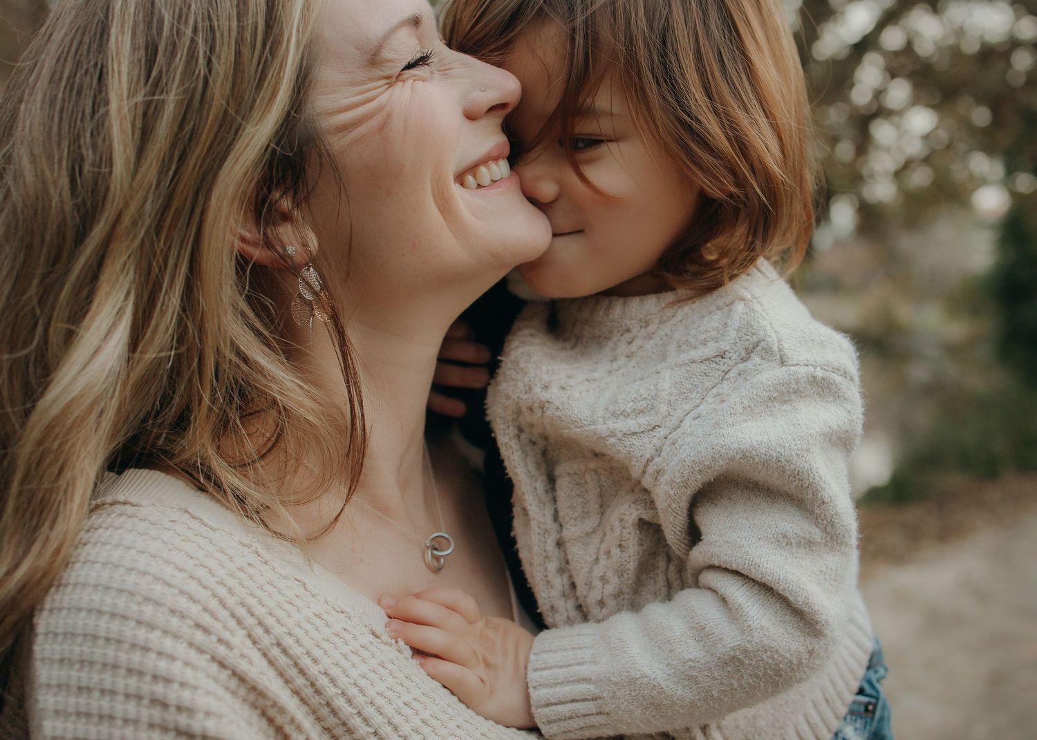 mom nuzzles toddler in a park in Davis