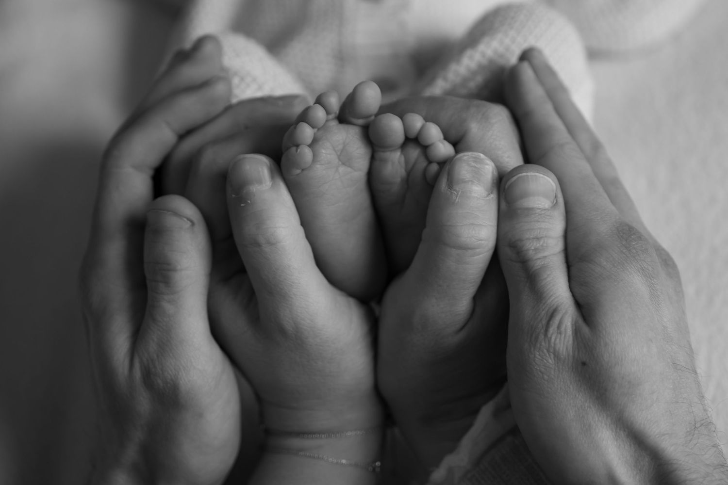 Newborn Photography - A peaceful newborn baby sleeping with a gentle smile on a red background.