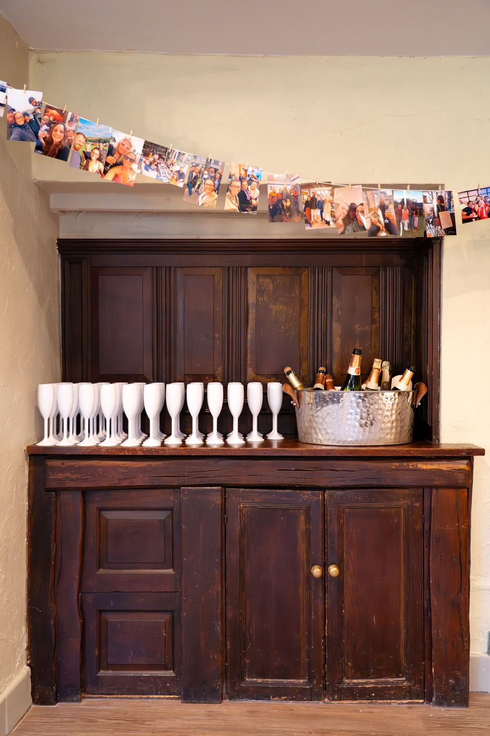 Arrival drinks for a wedding reception set up on an old cabinet in The Church House Inn Pub in Bollington, Cheshire.