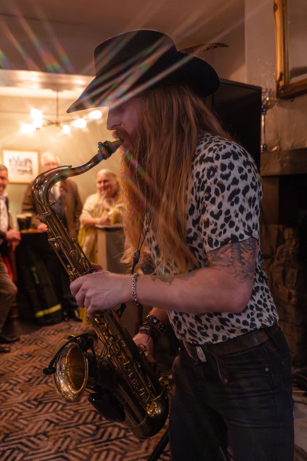 A saxophone player entertaining the guests in The Church House Inn pub which is located in Bollington Cheshire.