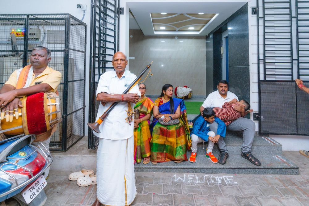 Musicians performing traditional music outside a building during a cultural celebration.