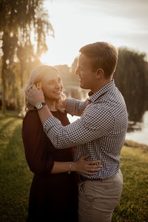 Romantic sunset portrait of couple embracing in golden light.