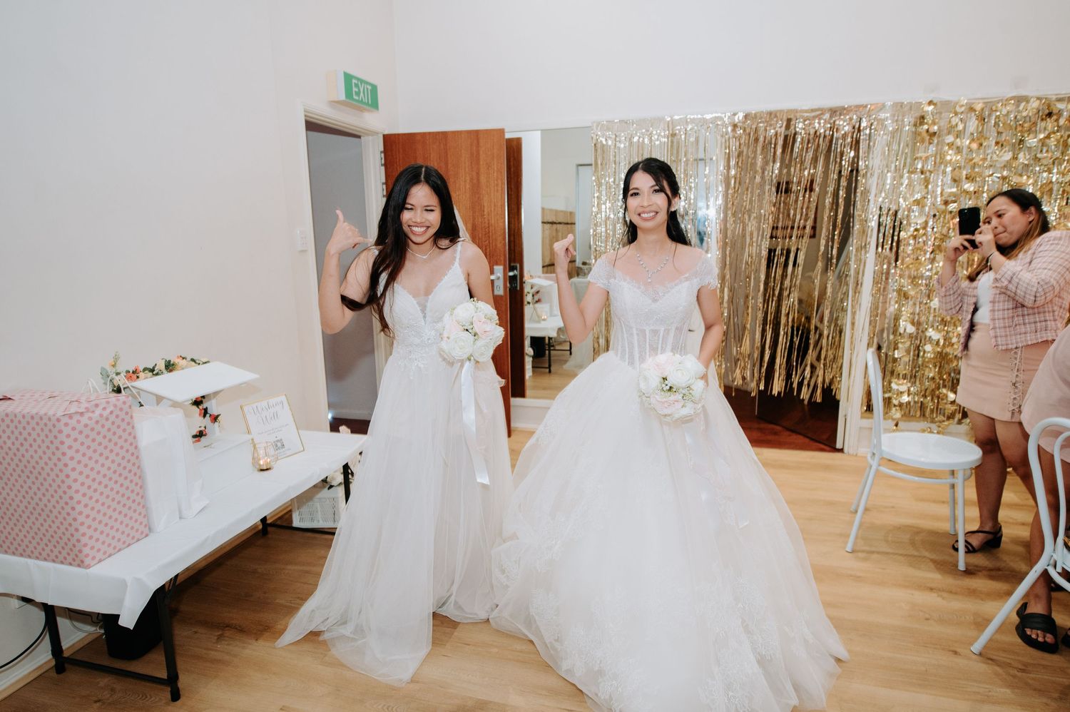 Wedding dress shopping scene with two dresses on display in a bridal boutique.