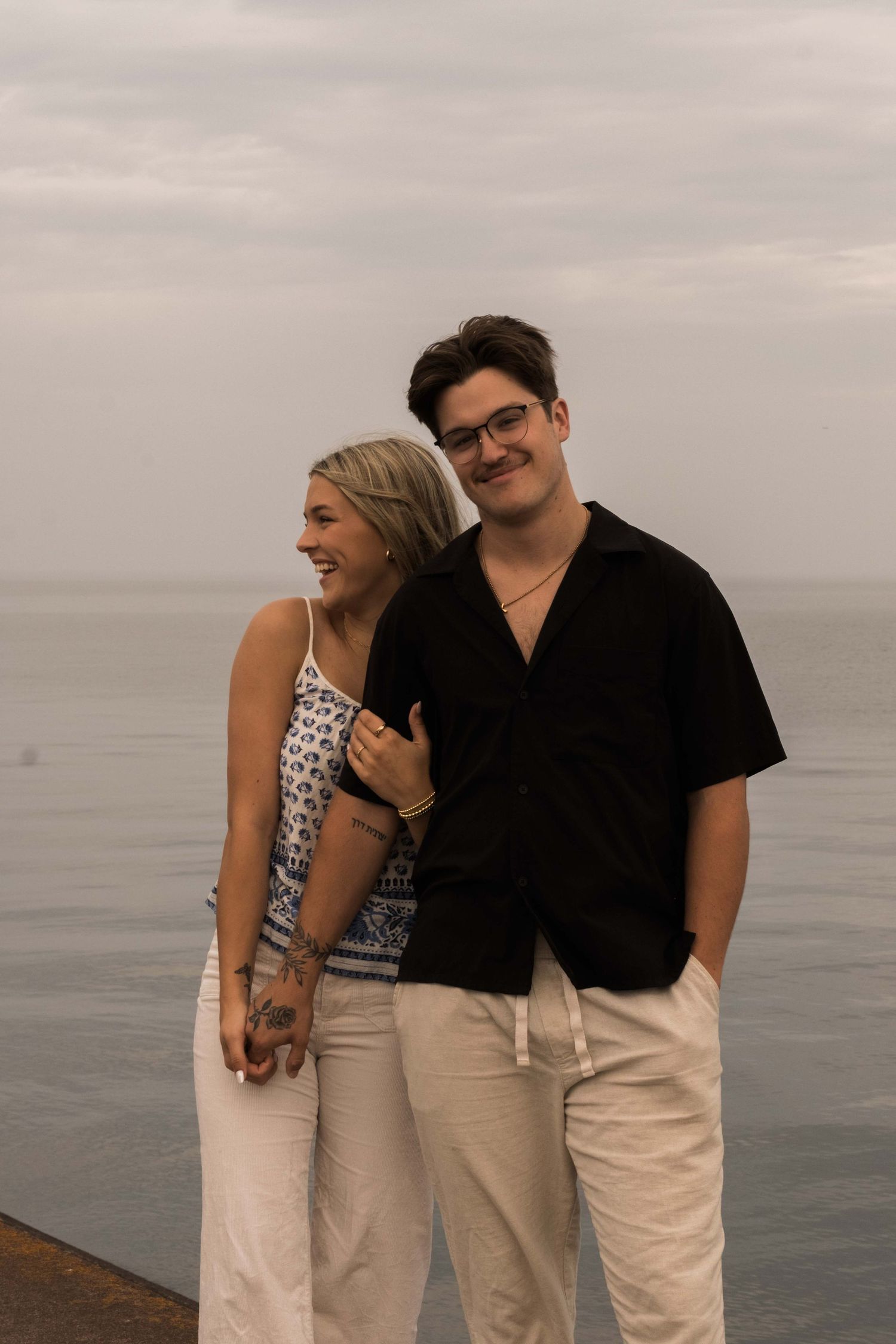 Photo of a couple in Two Harbours Minnesota with Lake Superior behind them