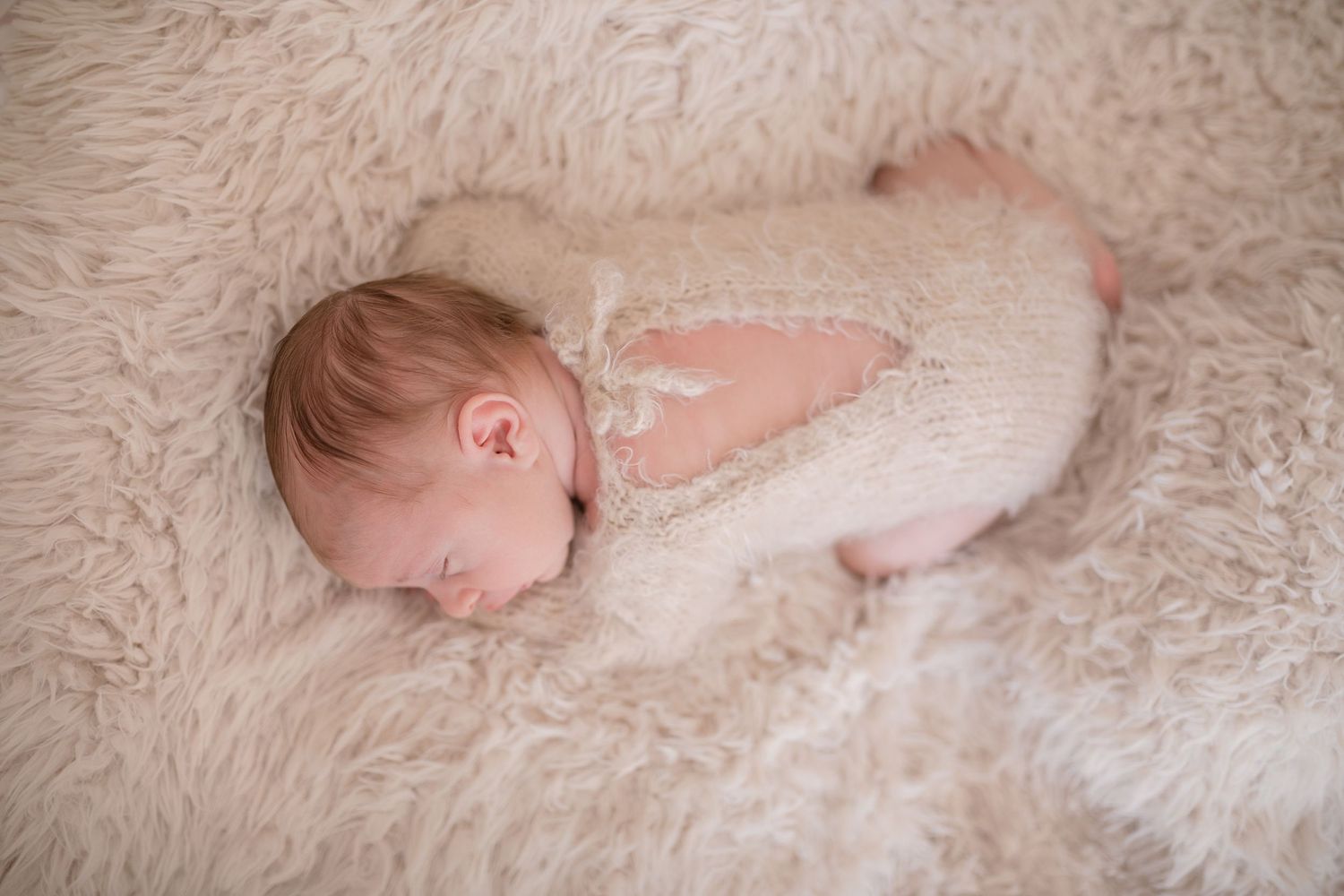 Peaceful newborn sleeping on soft cream-colored fur blanket. Photographer. Hull. East Yorkshire. Photography