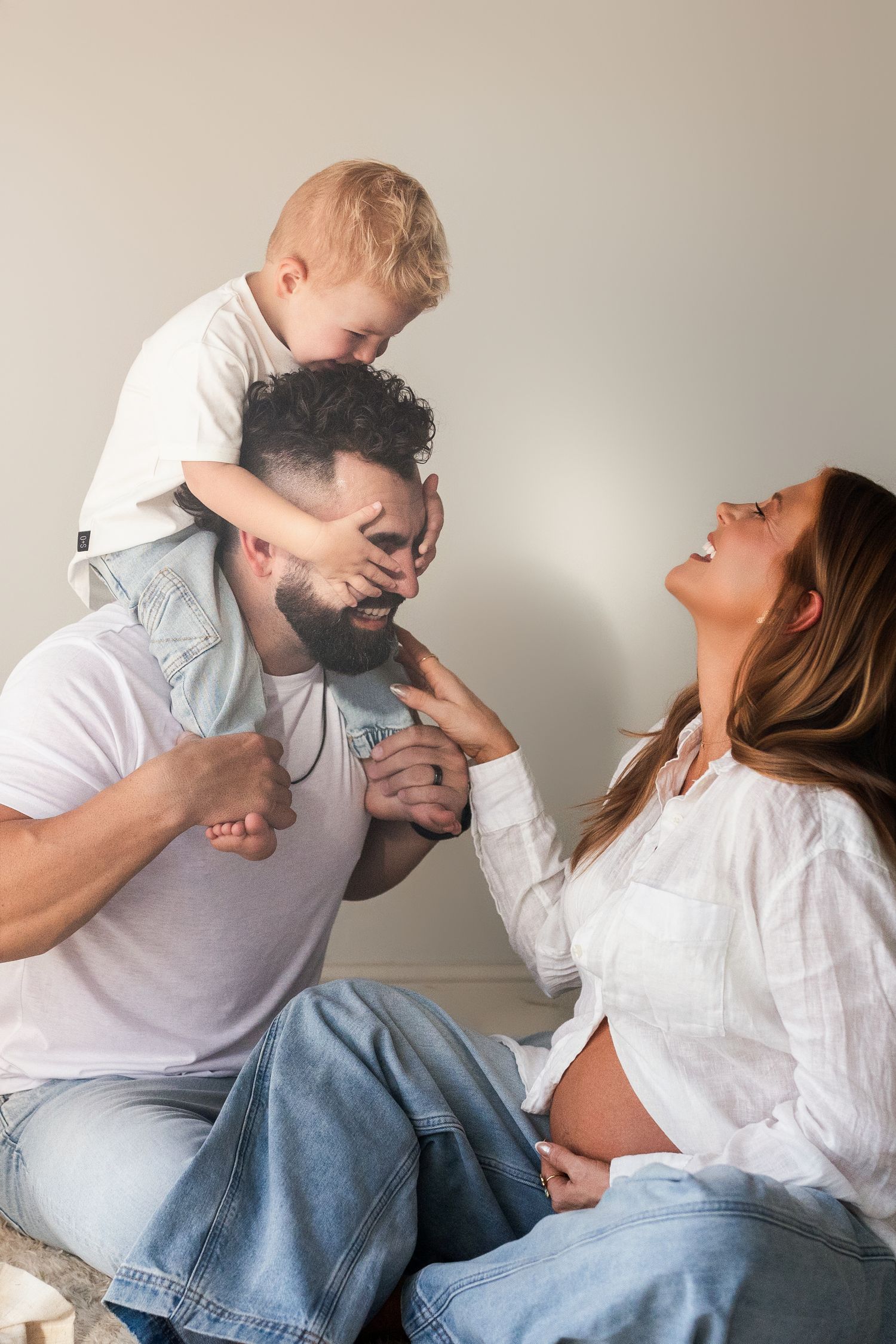 A series of four candid photos showing a playful moment between two people in casual white shirts and jeans.