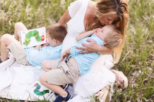 Tender parenting moments captured in a series of photos showing gentle interaction on grassy ground outdoors.