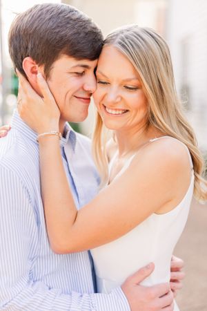 Intimate portrait of couple sharing romantic moment in soft natural light.