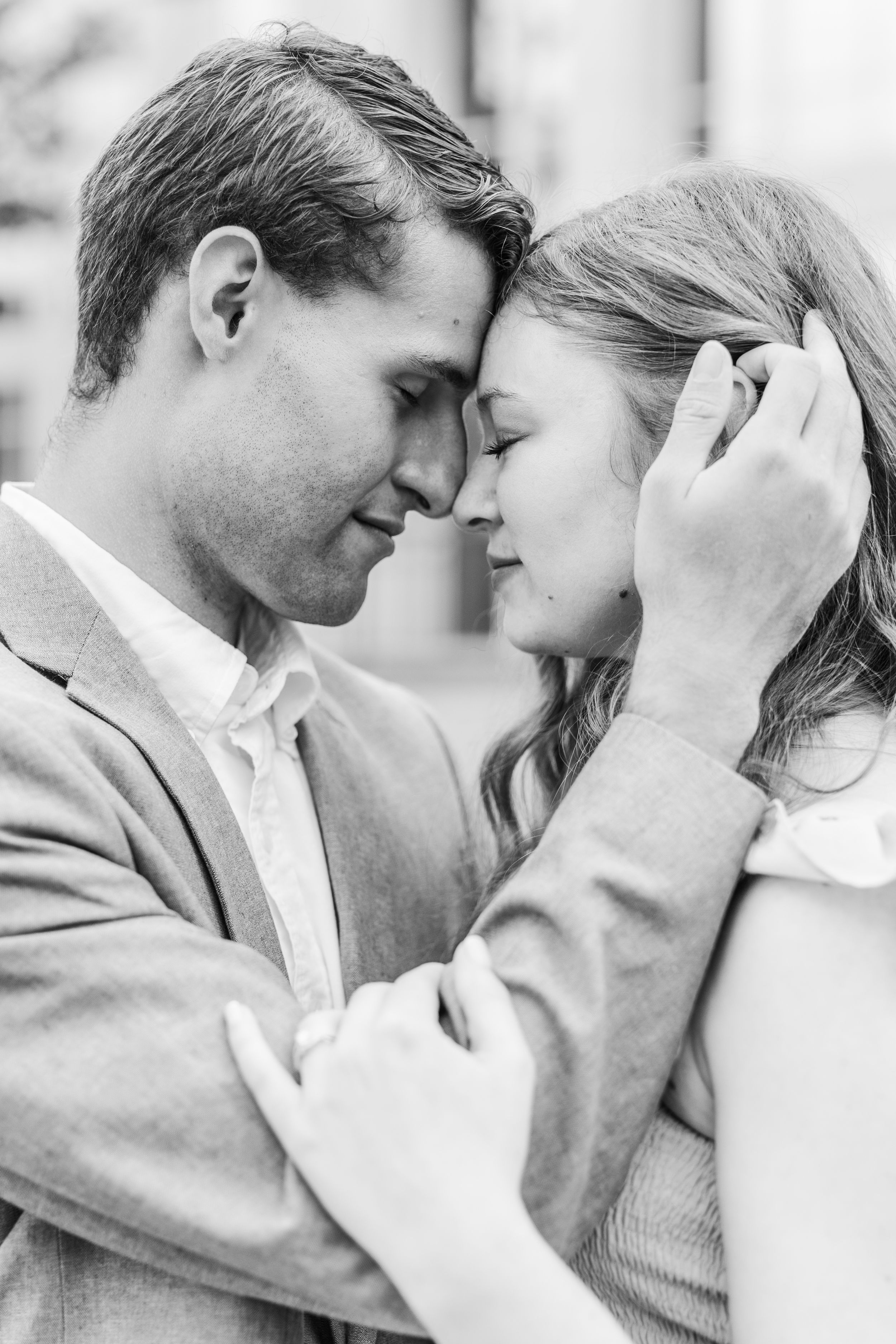Intimate black and white portrait of couple in tender embrace.
