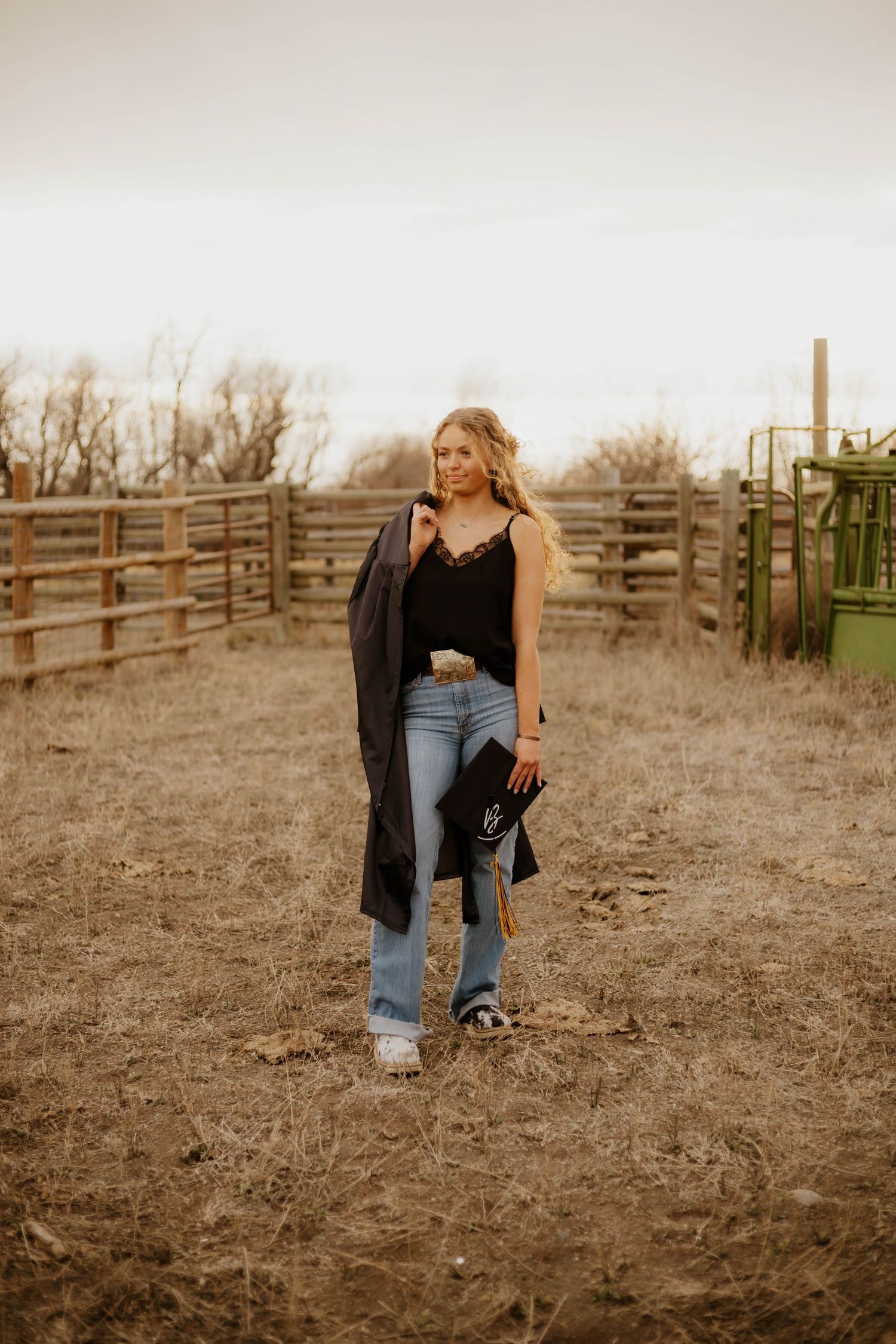 A western casual outdoor photoshoot near wooden fencing during sunset.