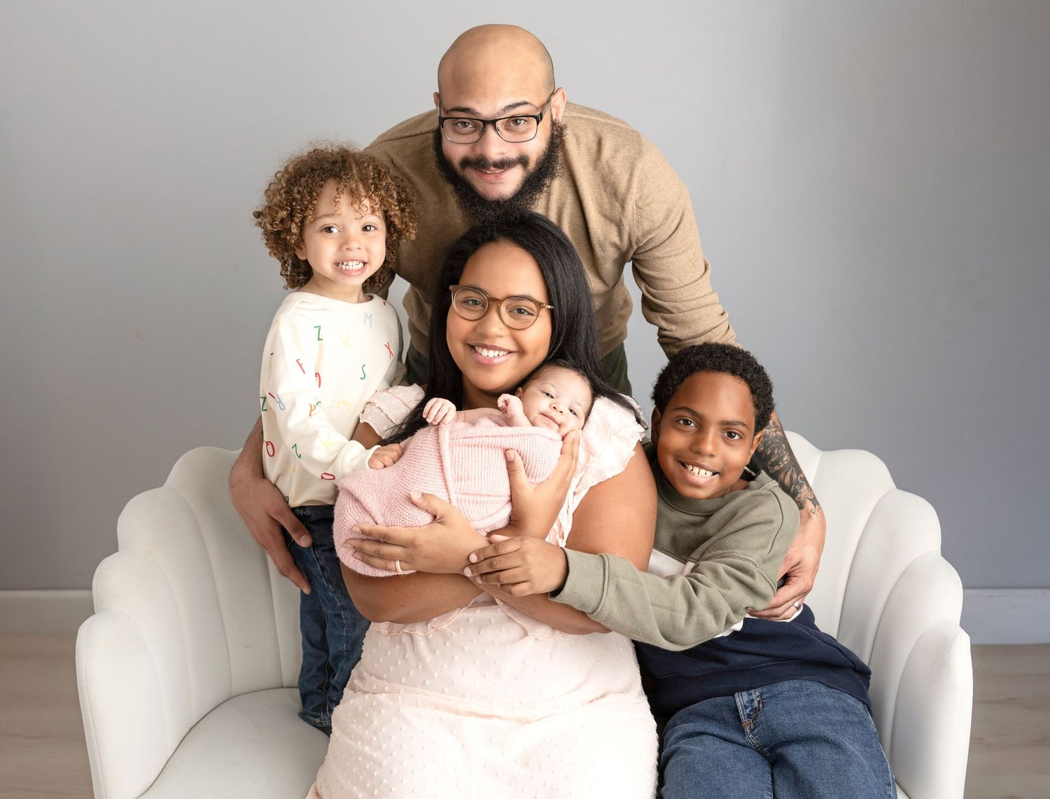 Cozy family photos on a white couch against a neutral gray background.