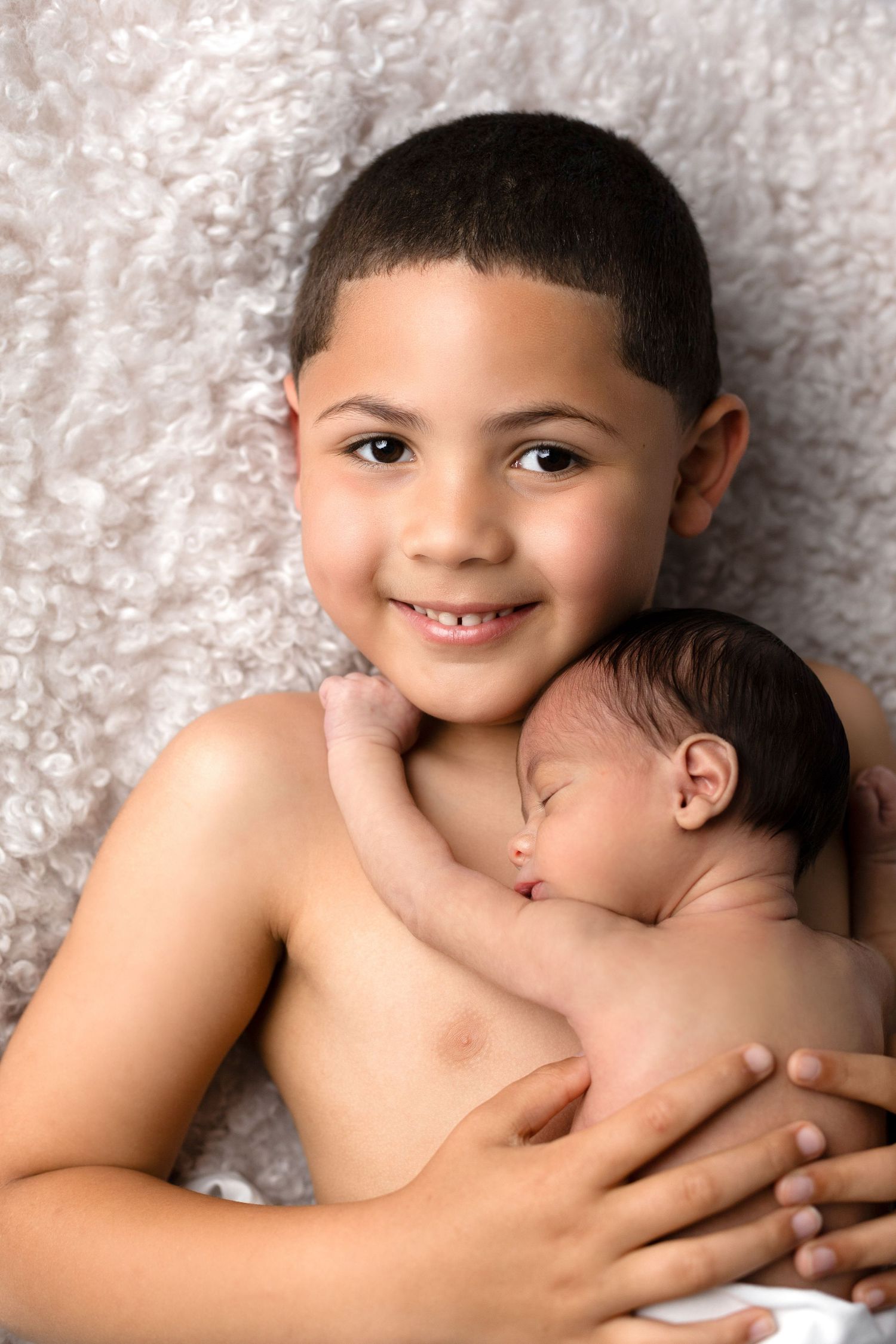 Sweet portrait of siblings on soft textured backdrop.