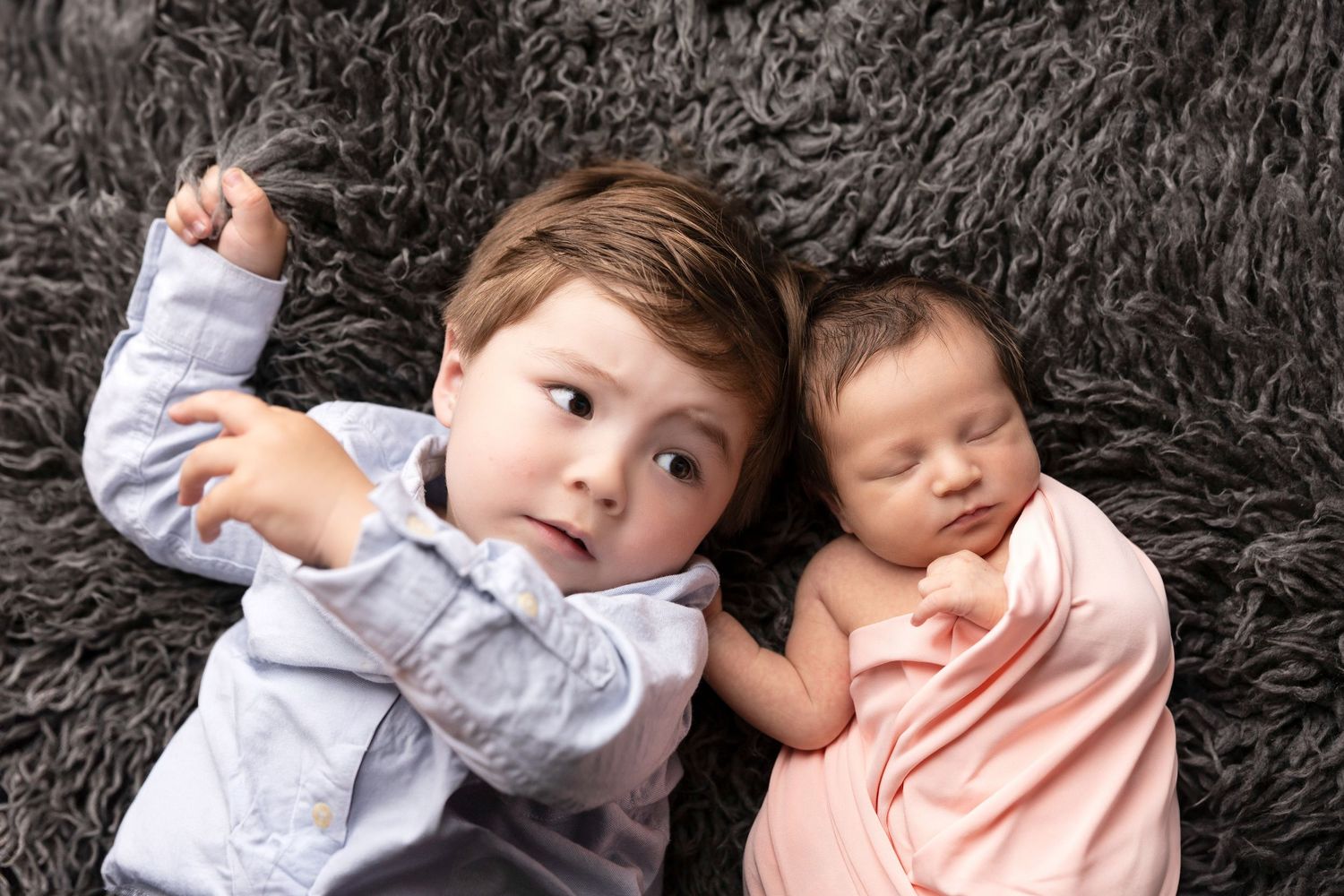 Candid family photos on dark background showing playful interactions.