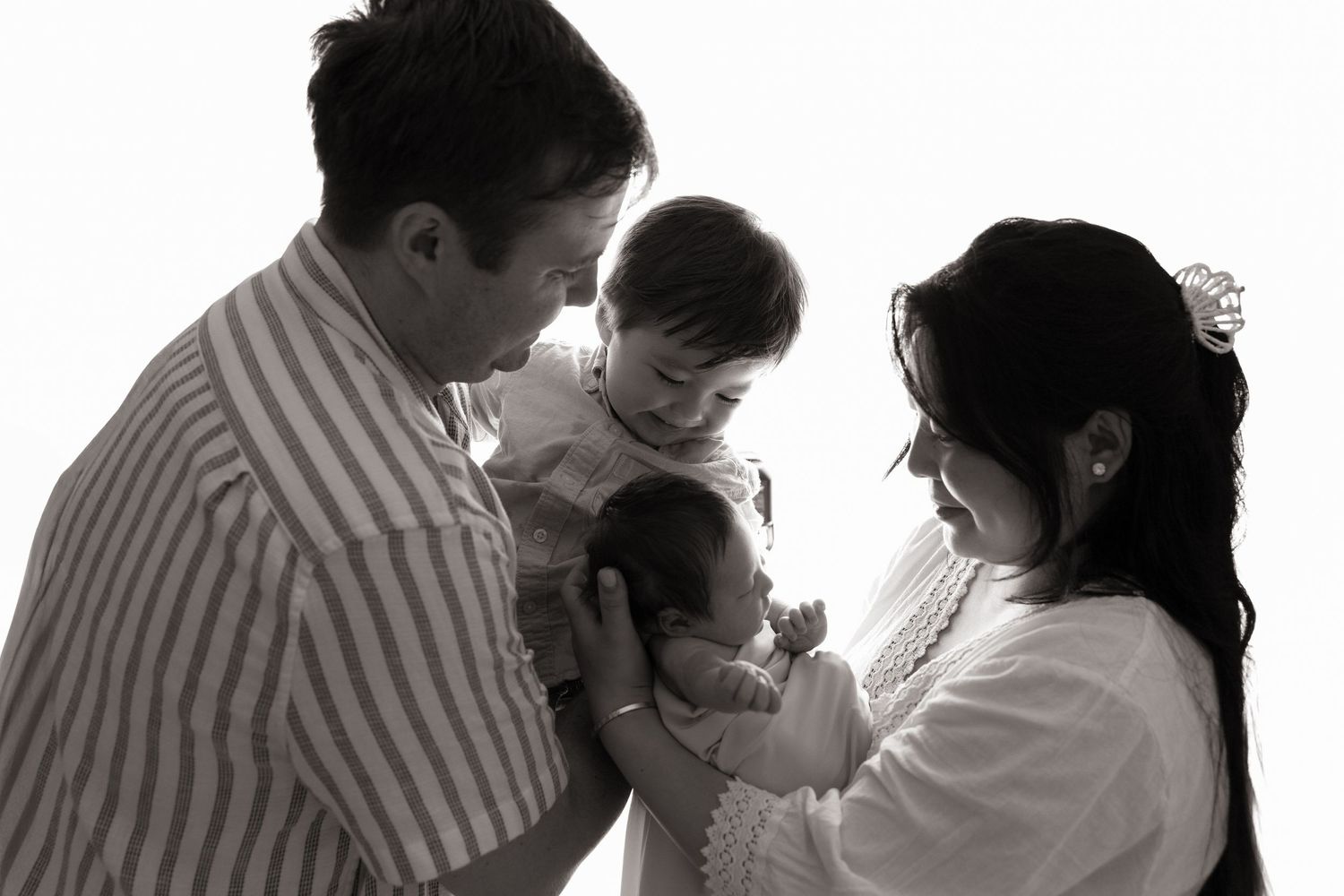 Black and white silhouette series of intimate family moments.