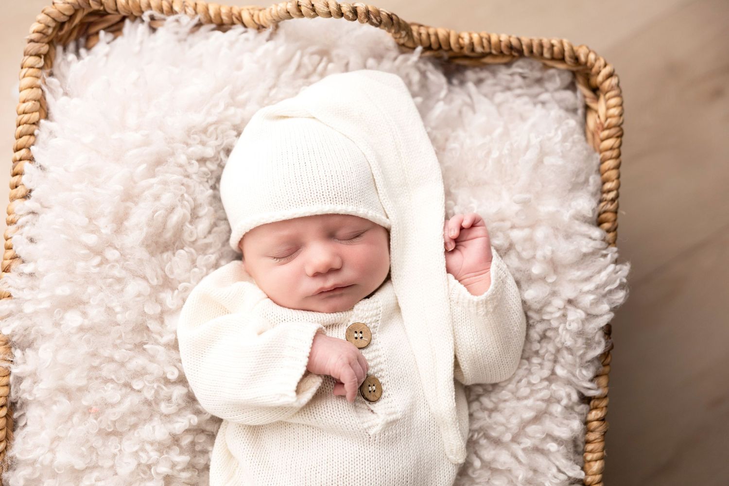 Newborn photography session with soft white blankets and delicate lighting creating a dreamy atmosphere.