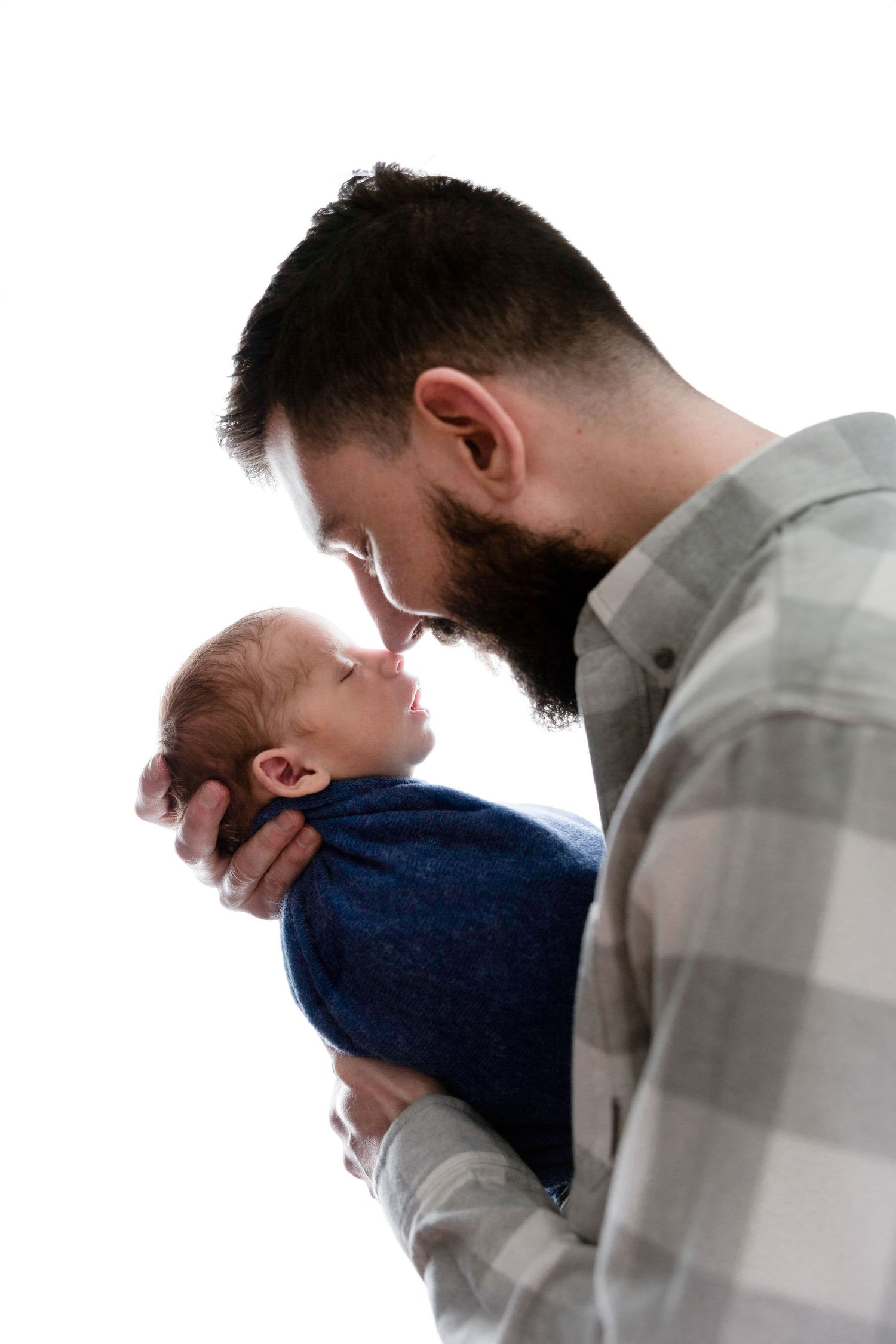 Series of close-up shots showing parent and baby bonding moments in white setting.