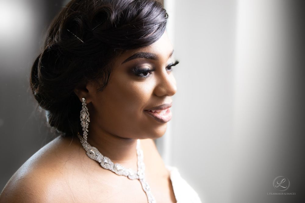 Elegant bridal portrait featuring dramatic side lighting and sparkling crystal jewelry.