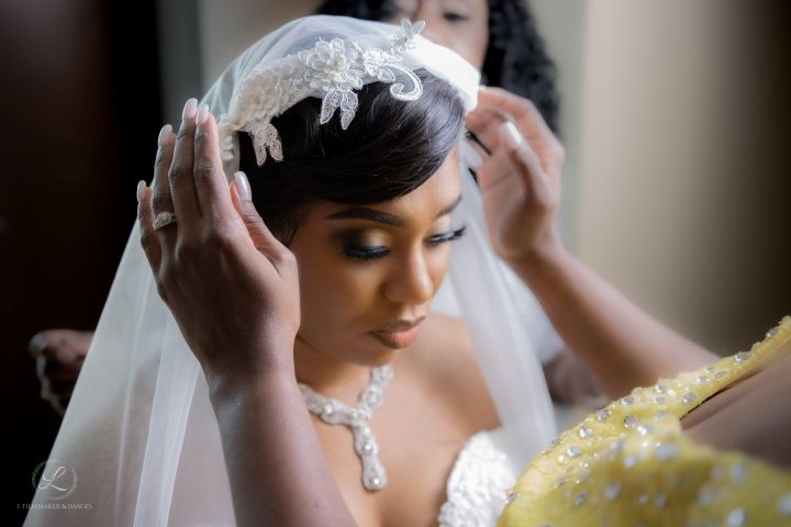 Intimate moment of veil placement during wedding preparation.