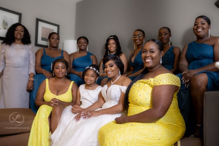 Joyful bridal party wearing vibrant yellow dresses posed together for group photo.