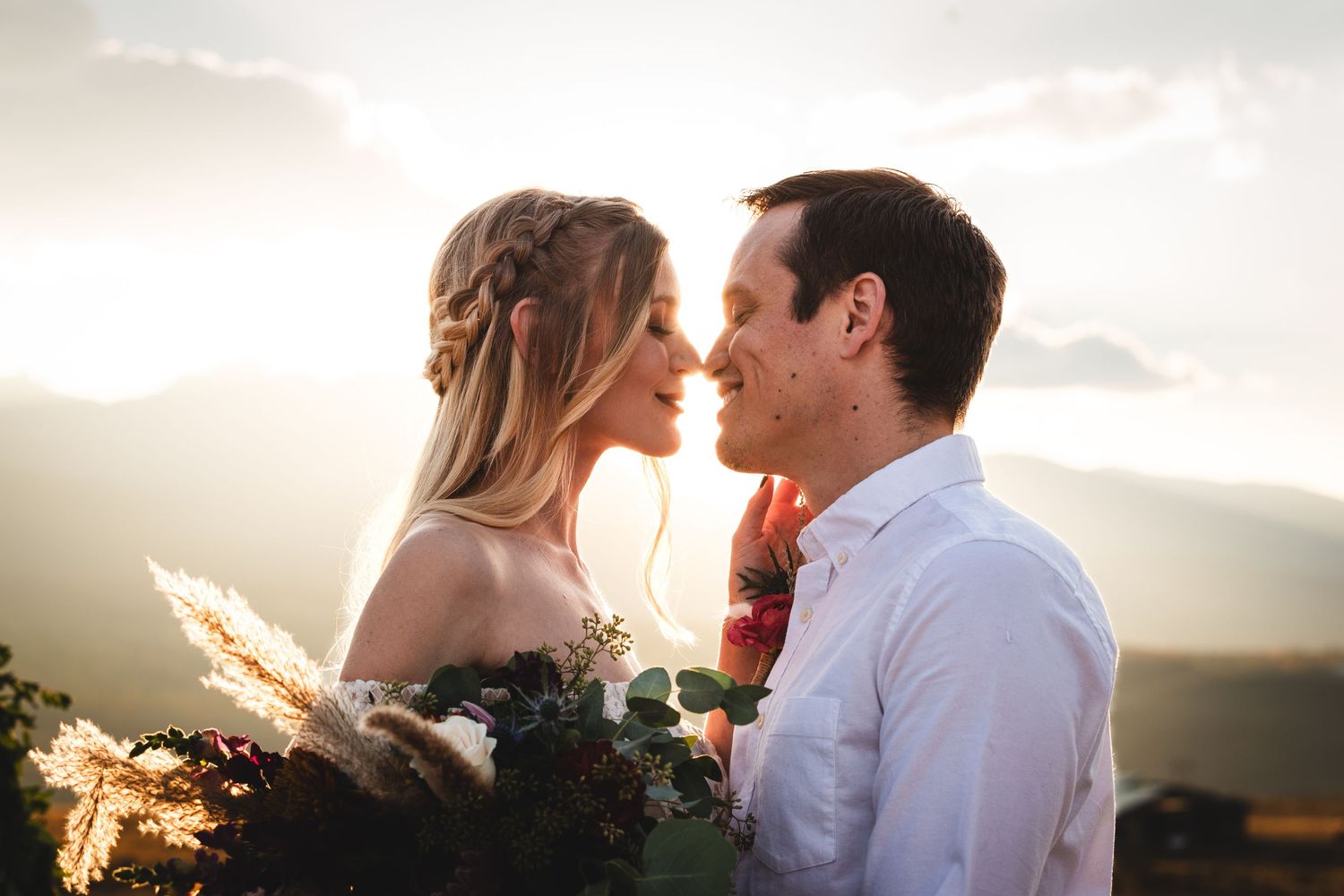 Romantic couple close together at sunset with mountains in background, in Silverthorne, Colorado - Wedding