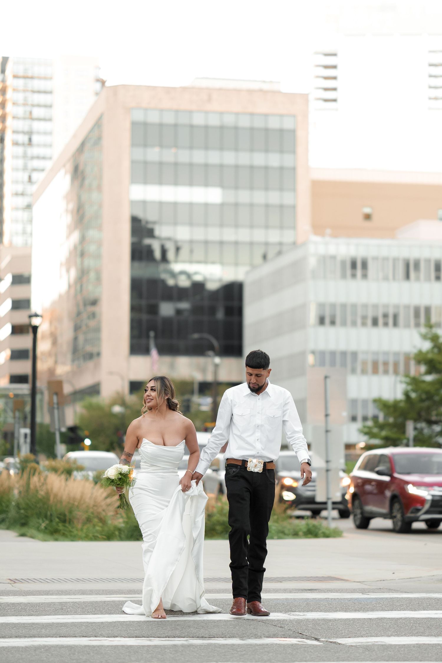 A wide-angle wedding photo sequence showing a couple dancing on a city street.