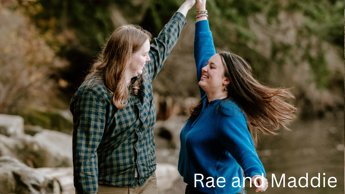Two people high-fiving with excitement against a natural outdoor backdrop.