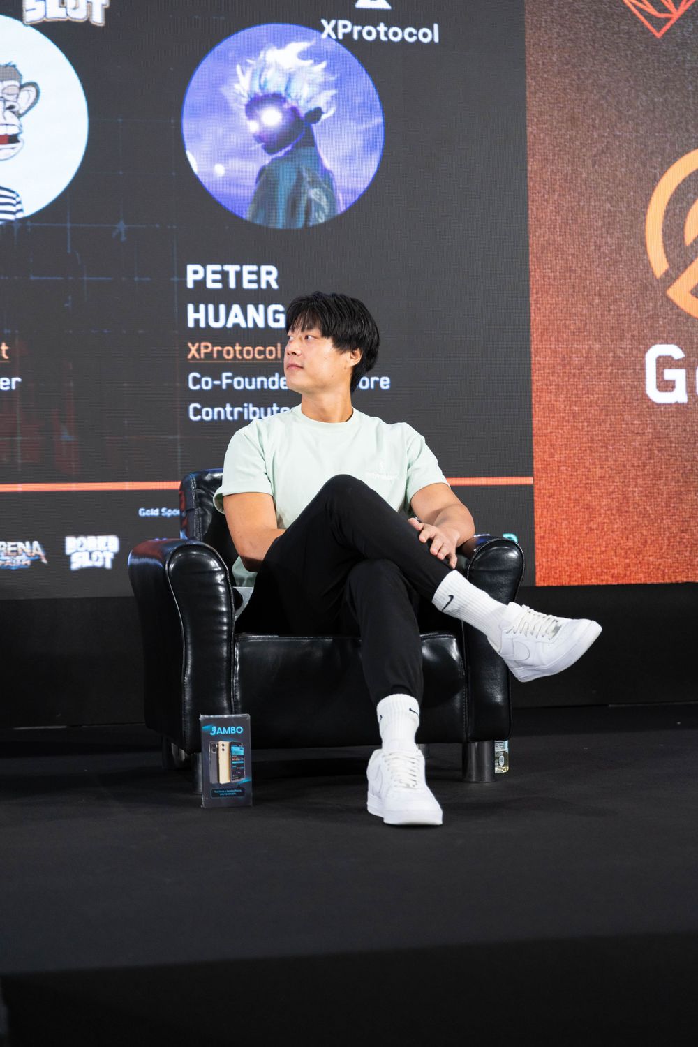 Peter Huang, XProtocol Co-Founder, speaks on stage at a Web3 gaming conference panel.