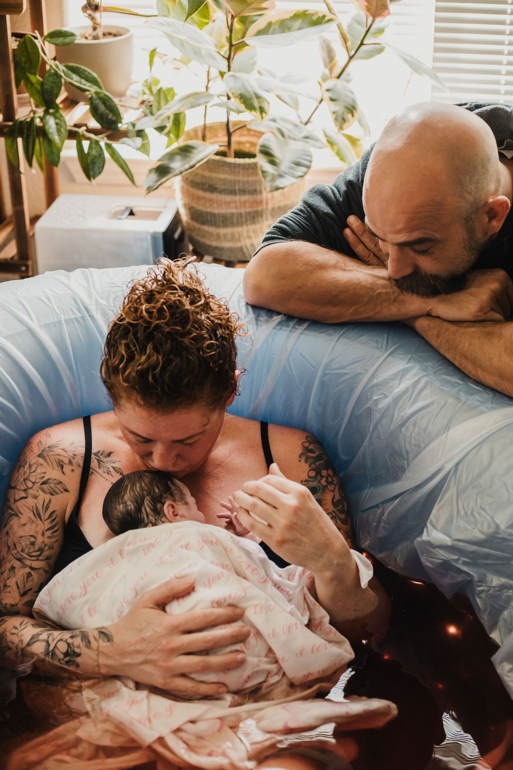 mom and dad adore their newborn after home water birth Lake Tahoe birth photography