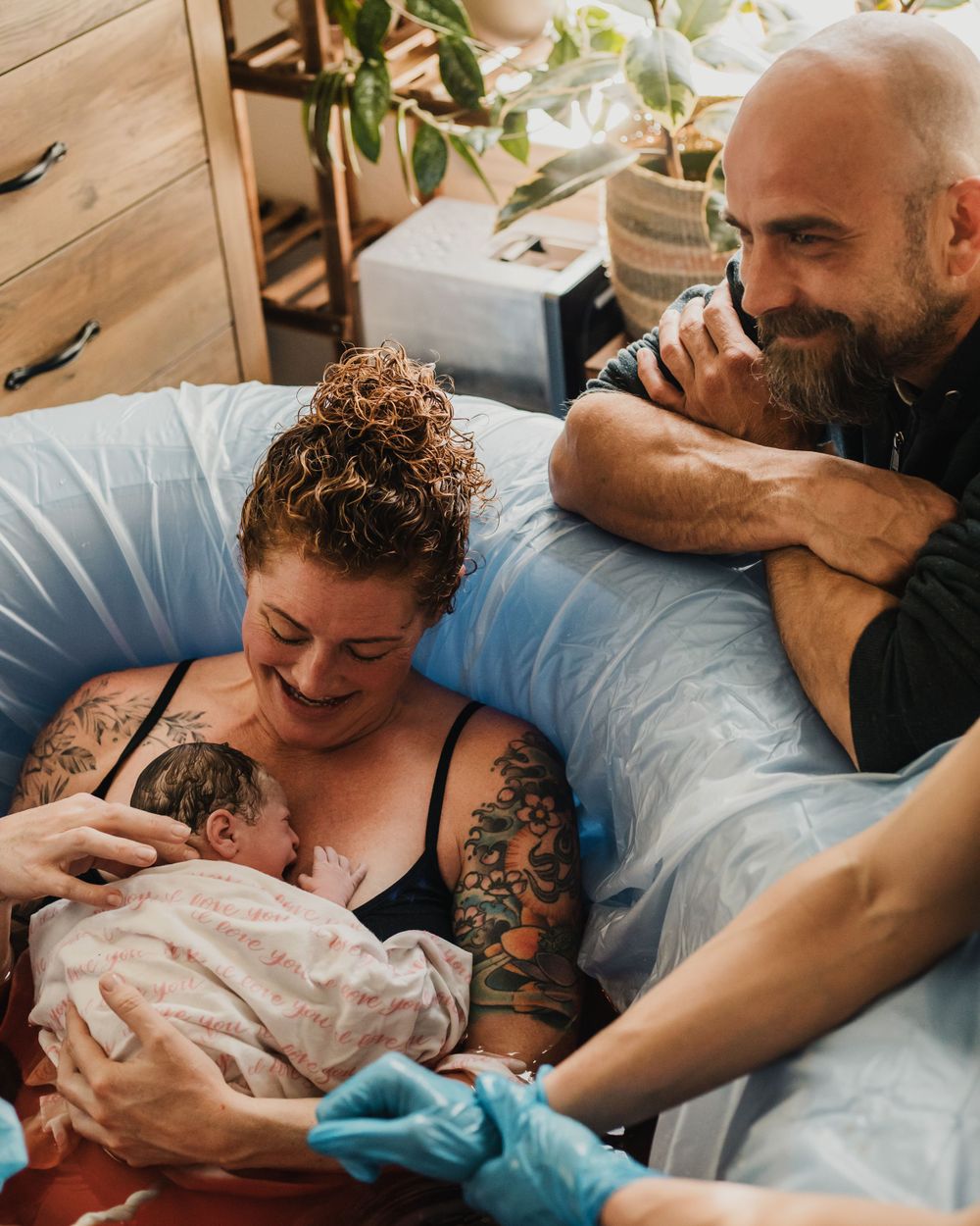 mom and dad adore their newborn after home water birth Lake Tahoe birth photography