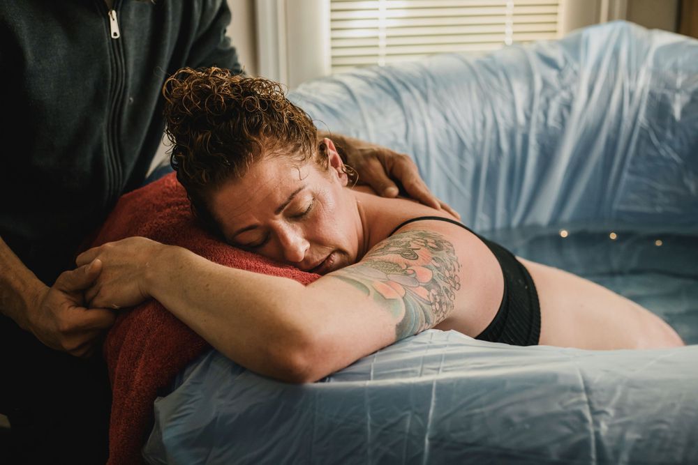 Home Birth photography laboring mother in birthing pool Carson City Nevada