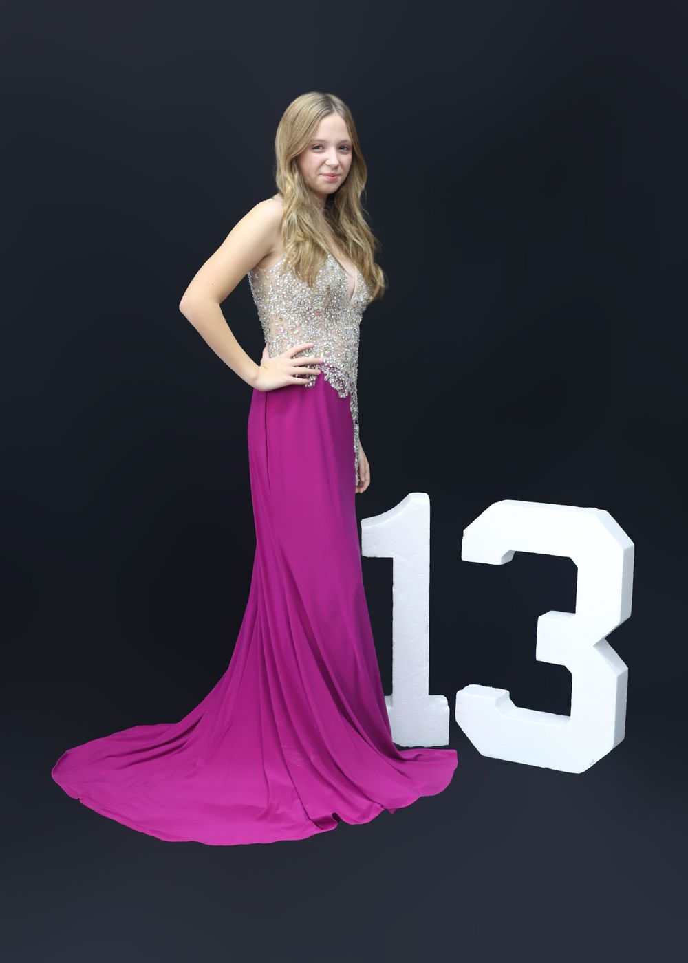 Formal dress photo with number 13 against black background.
