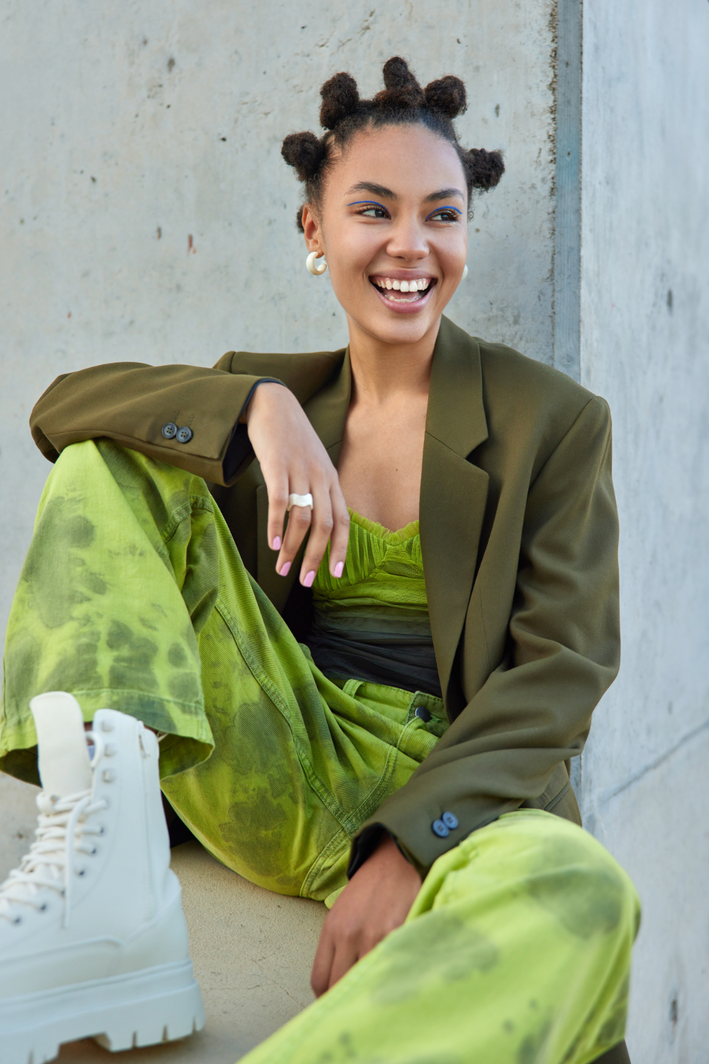 model in green outfit and smiling