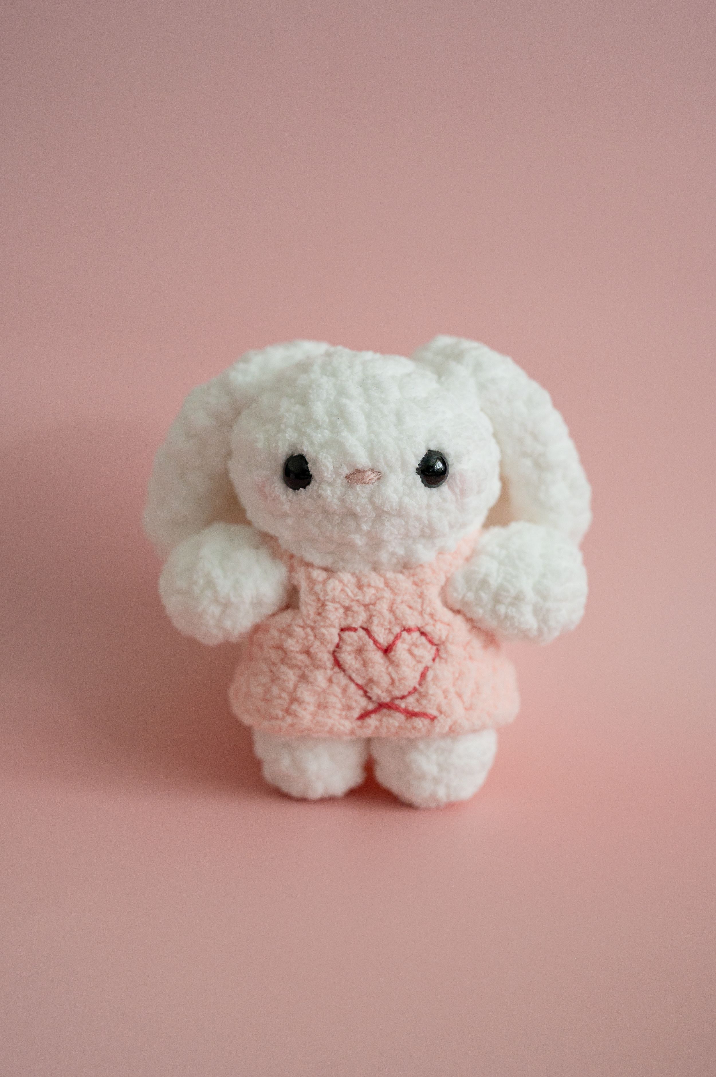 Adorable white and pink plush toy bunny photographed at different angles against a soft pink background.