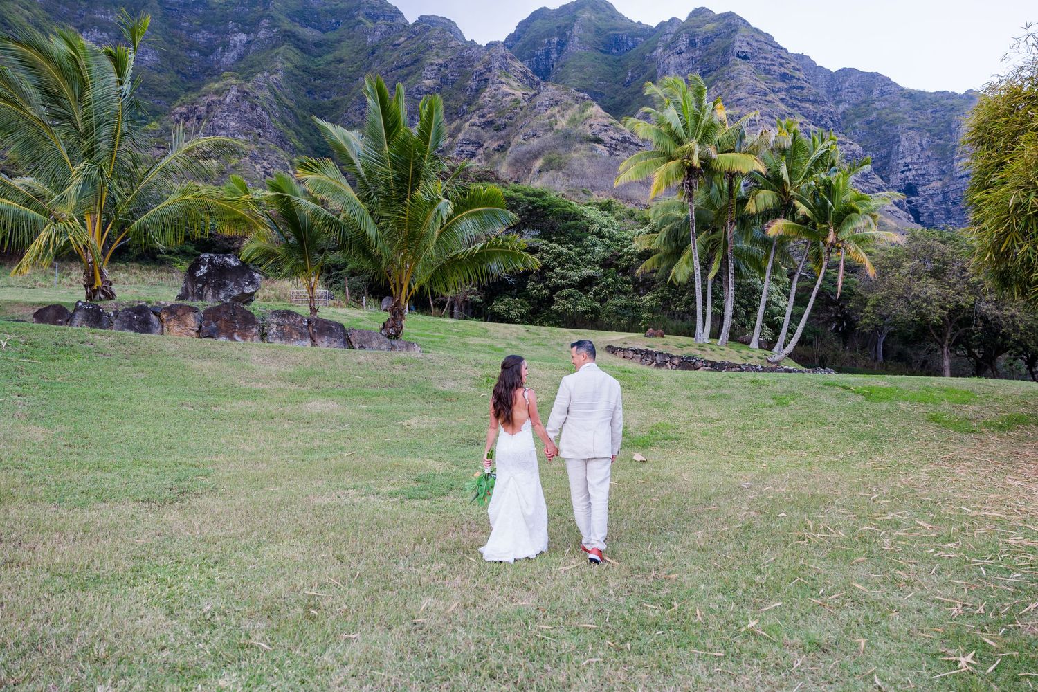 Bride and groom walking away in Hawaii