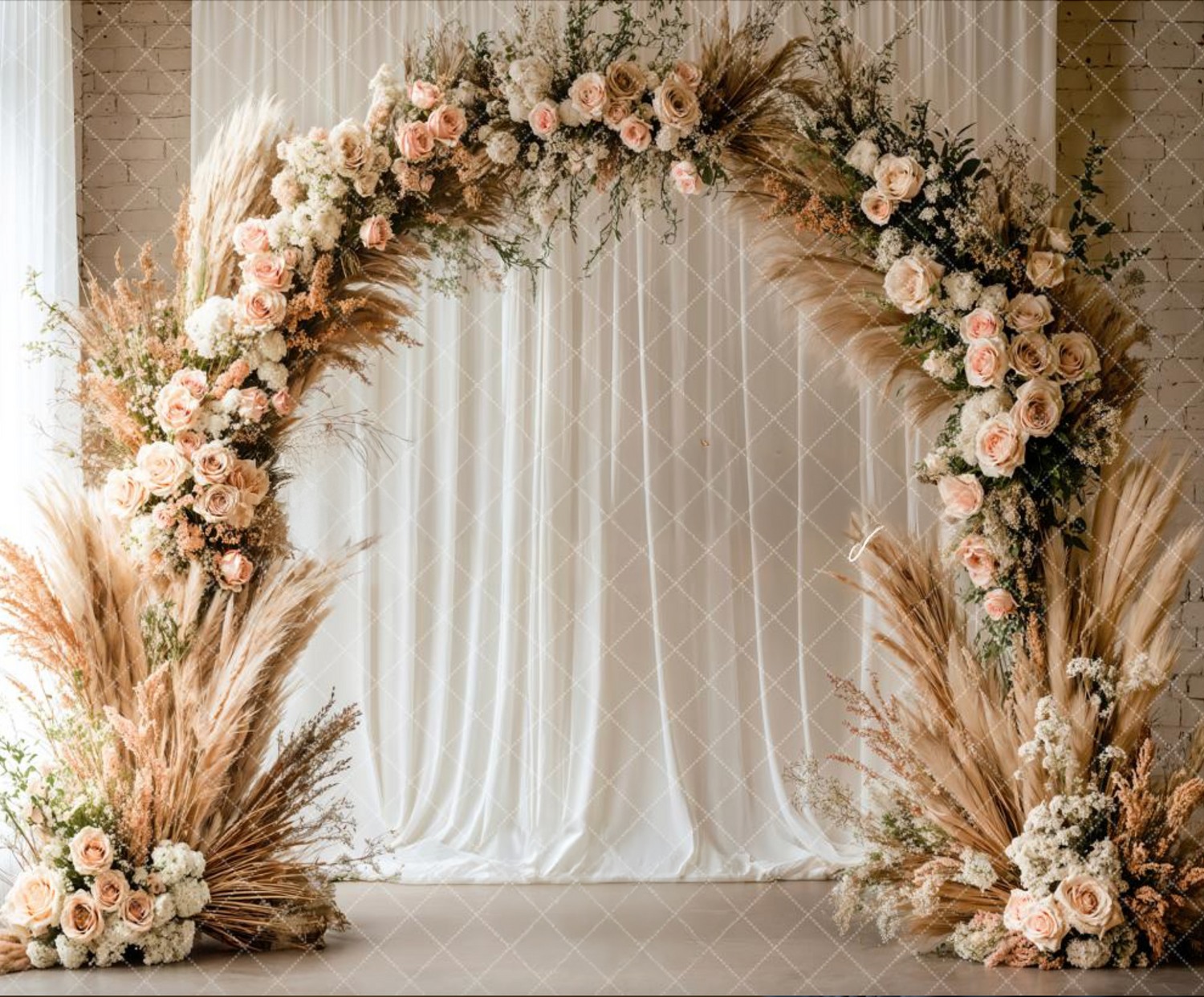 Romantic floral wedding arch with pink roses, pampas grass, and white curtain backdrop against neutral wall.