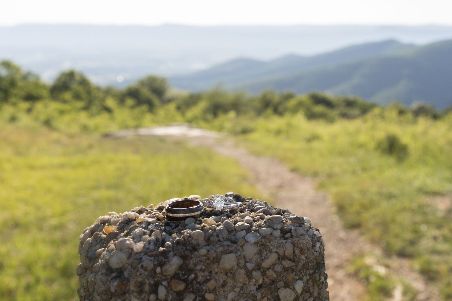 Wedding rings are shown on top of a trail marker in Shenandoah National Park at Pass Mountain Overlook.