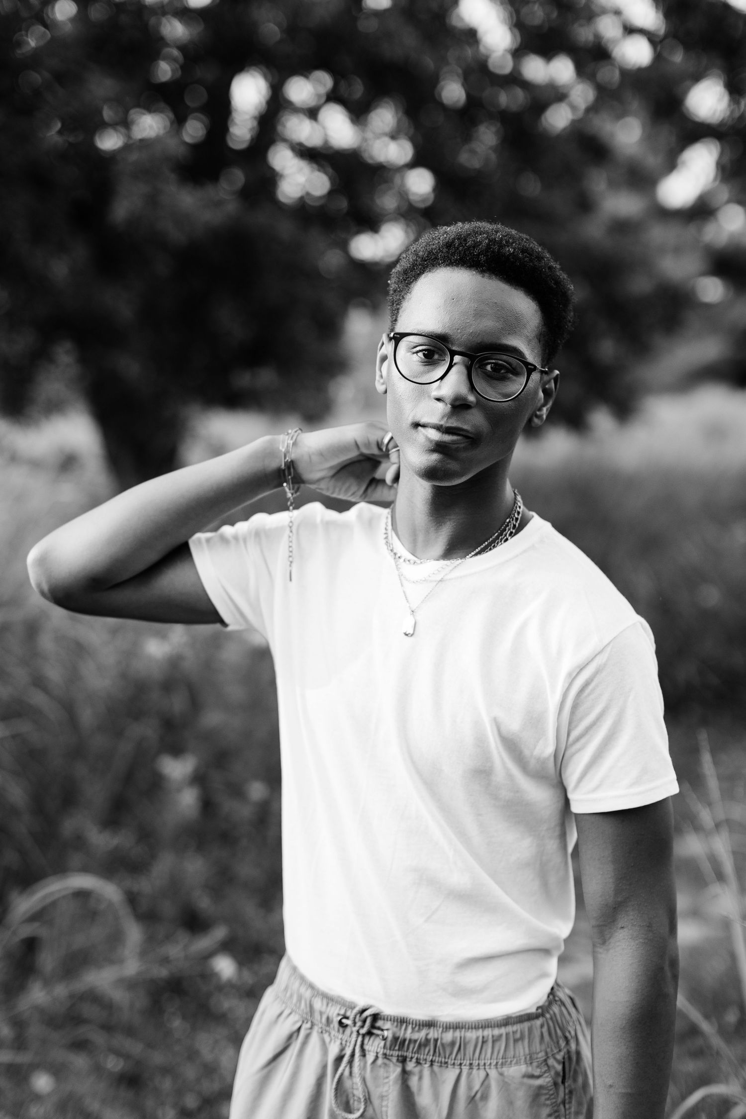 Black and white portrait of person in white t-shirt making a gesture.