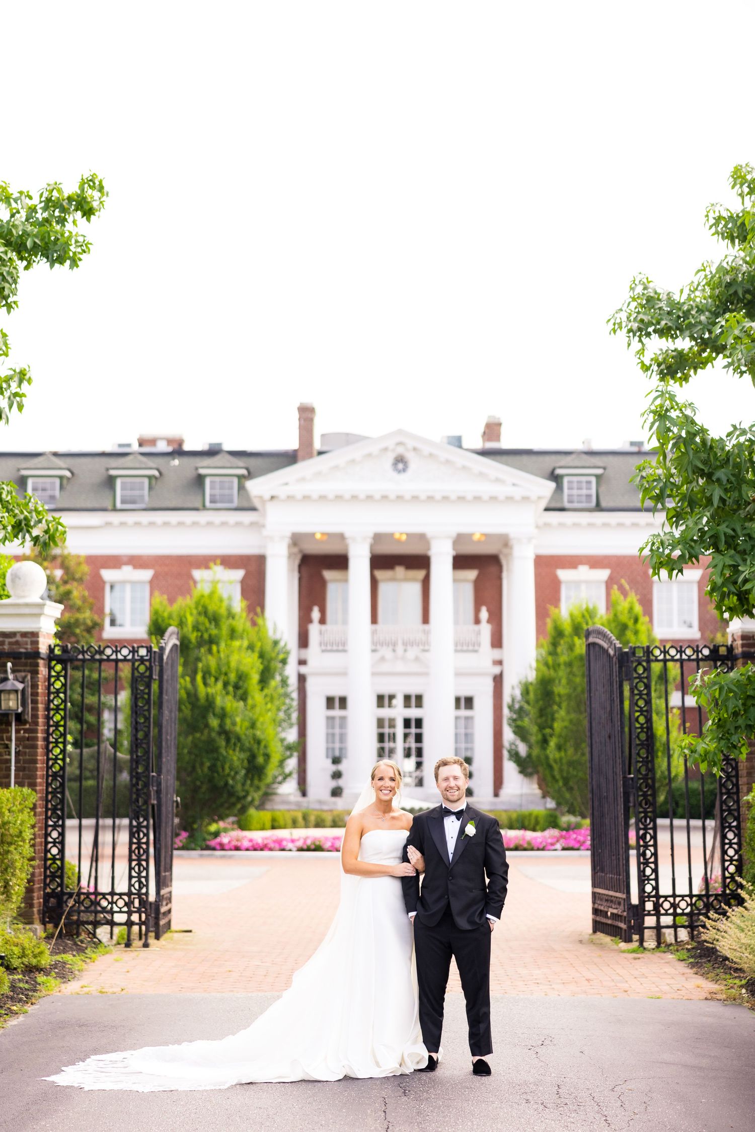 Couple standing in front of bourne mansion