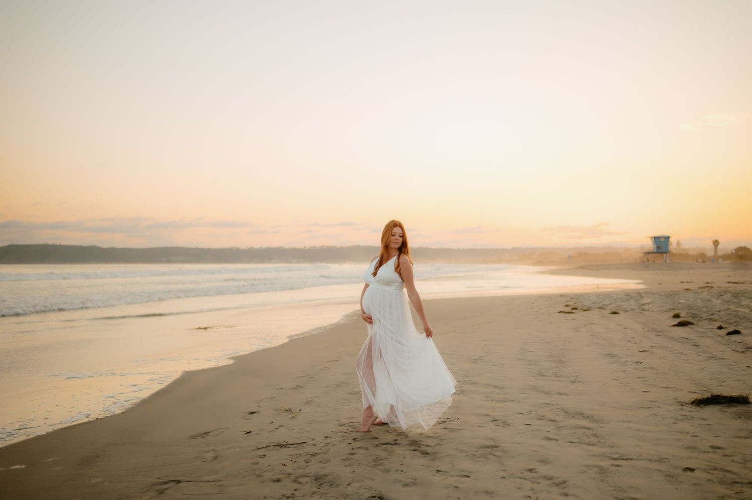 pregnant woman posed on sand in Santa Barbara during her sunset maternity photoshoot by Ventura County photographer