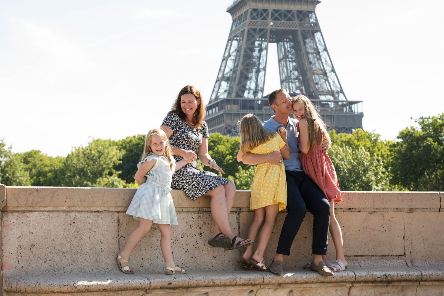 A family photoshoot at the Eiffel tower from the bridge Bir-Hakeim
