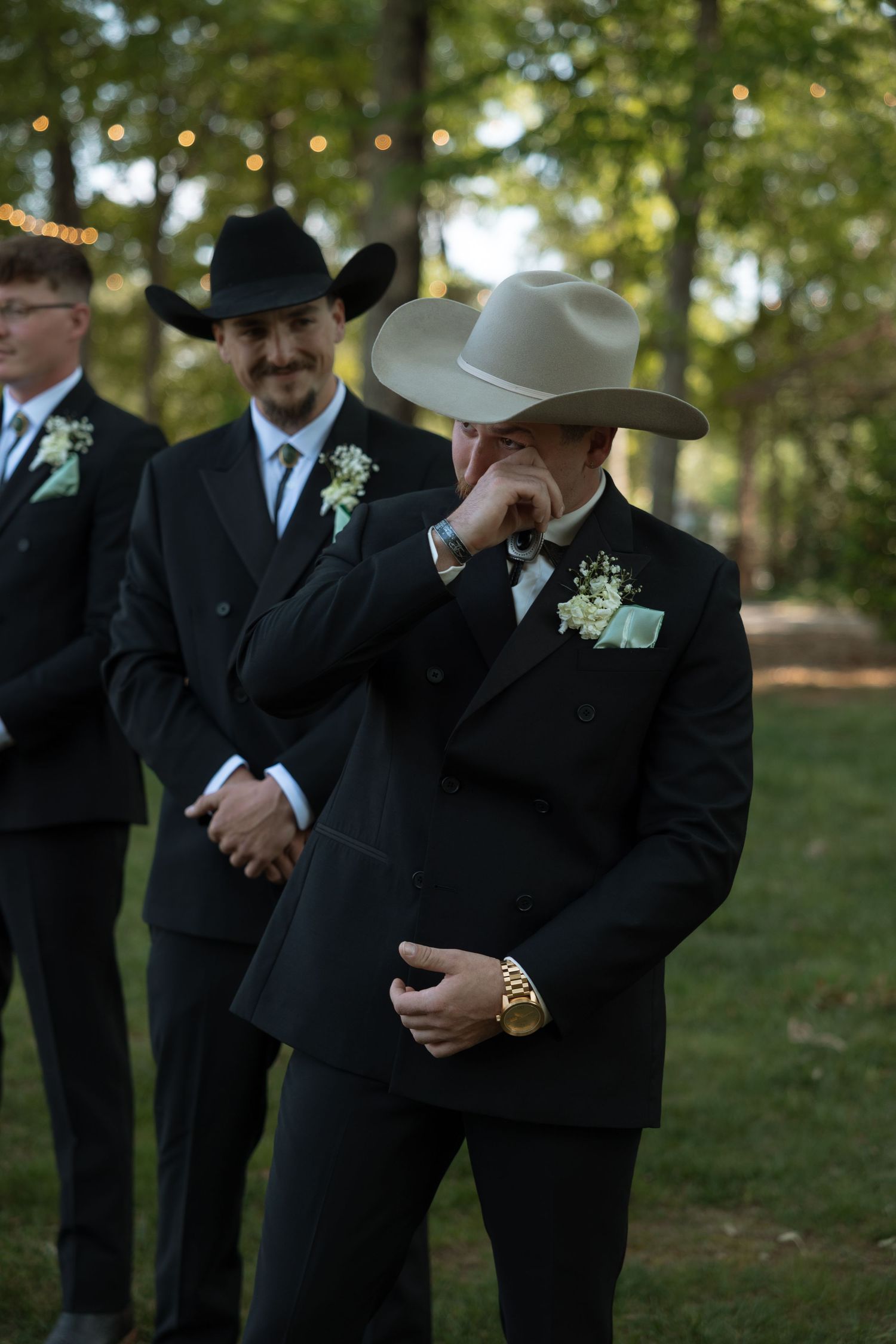 Wedding couple sharing intimate moment outdoors in elegant white attire.
