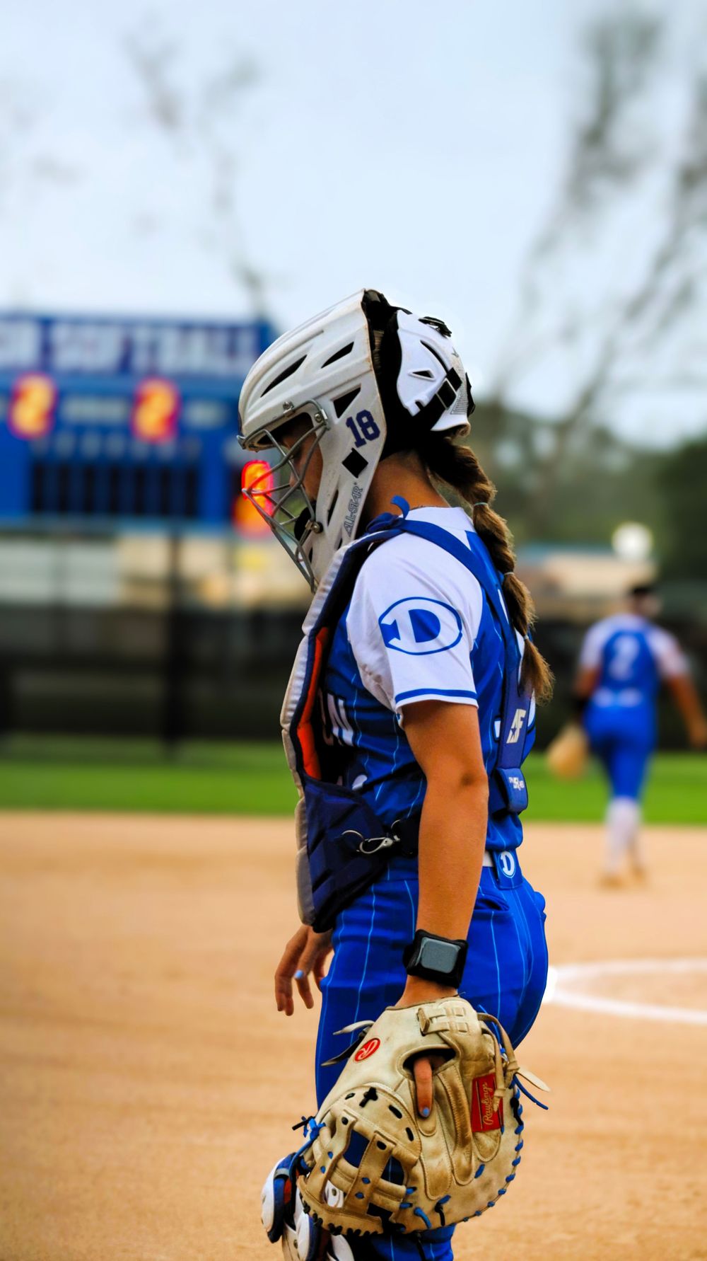 Close-up sequence of softball catcher's stance and positioning behind home plate.
