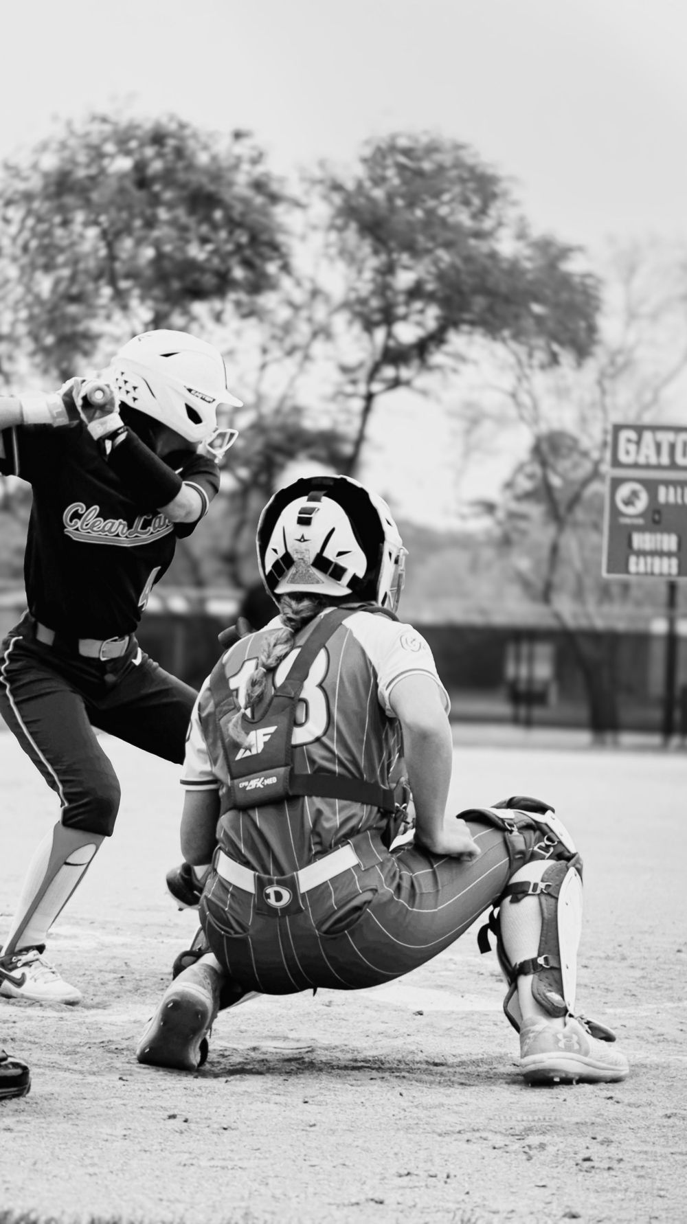 Black and white sequence showing softball catcher's defensive positioning during game play.
